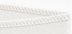 Close-up of overlock serged stitching on a commodity liquid filter bag showing high-risk bypass paths